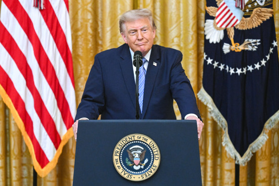 Donald Trump stands at a podium