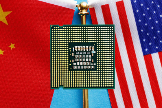 Photo illustration of a computer chip in front of a China flag and an American flag