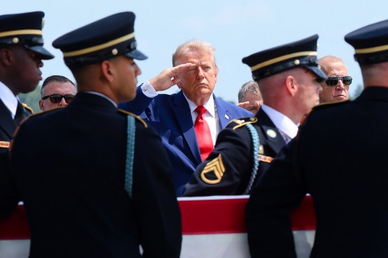 Donald Trump salutes as members of a U.S. Army carry team move the flag-draped transfer case