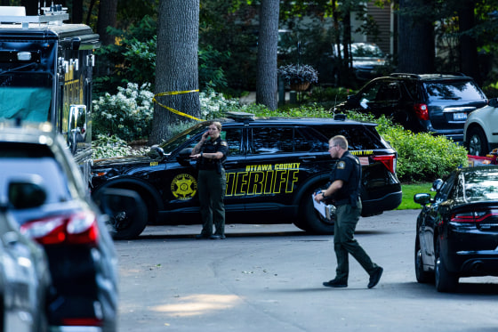 Law enforcement investigate the scene of a fatal house fire in Grand Haven Township in Michigan.