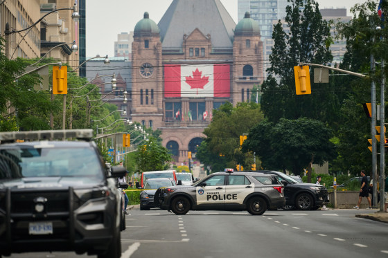 Police work the scene of an early morning shooting outside the US Consulate in Toronto.