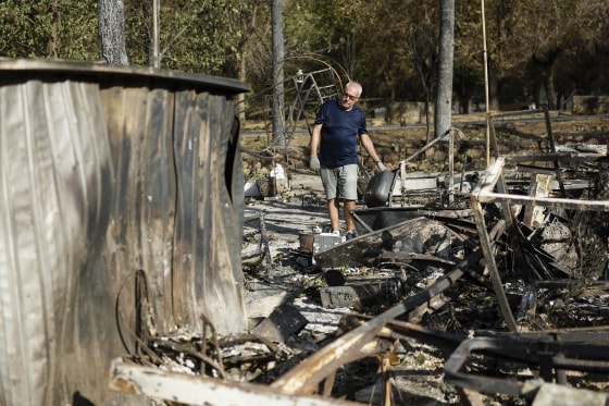 A man searches through the rubble 