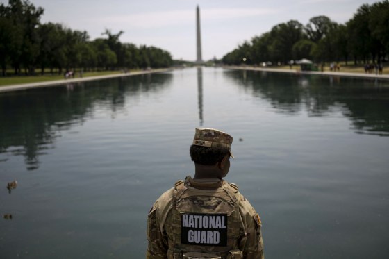 A member of the National Guard patrols along the rim of the Lincoln Memorial Reflecting Pool in Washington D.C.