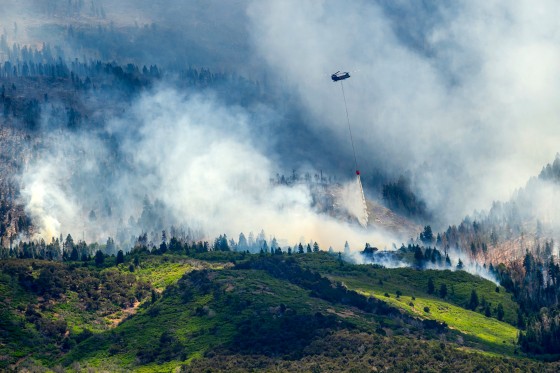 Helicopter drops water on the fire.