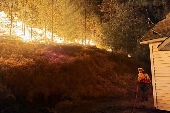 A firefighter battles the Fairview Fire in Spokane County, Wash.