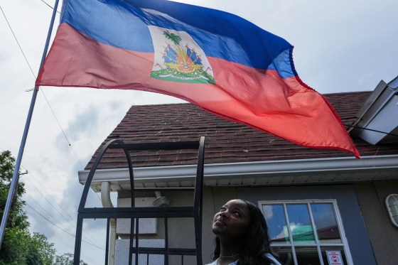 Patricia Grace Louis-Jacques with the Haitian flag.