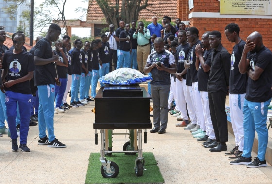 Ugandan soccer players pay homage around the coffin of SC Villa captain David Owori in Kampala on Aug. 6, 2026.