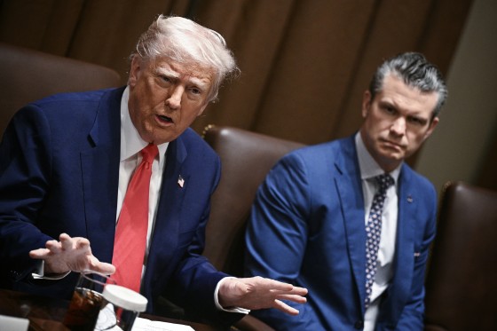 Donald Trump speaks while sitting next to Pete Hegseth at the table.
