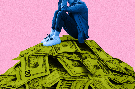 A woman (colorized in blue) who is crouched with her hands covering her face, seated atop a large pile of dollar bills (colorized in lime green), 20s, 10s, 5s and 1s can be seen in the mountainous pile, all against a pink background