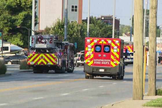 A fire truck and emergency vehicle are seen on the street