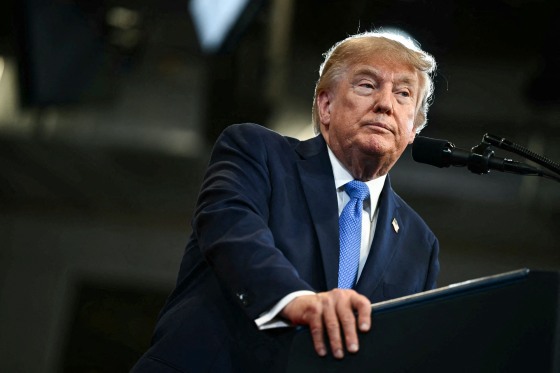 Donald Trump stands at a podium on stage