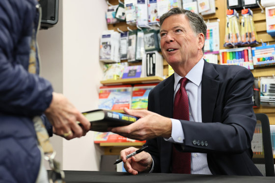 James Comey signs copies of his crime novel "FDR Drive" in New York in 2025.