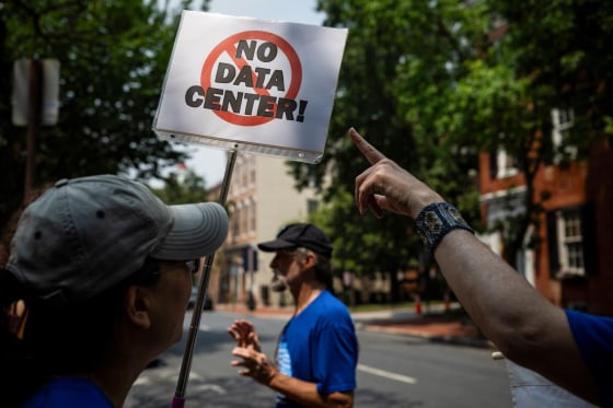 Demonstrators in the street hold a sign that says; "No Data Center!"