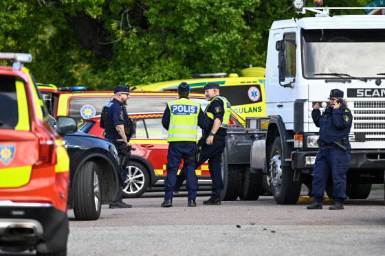 Police officers and rescue services work at the scene.