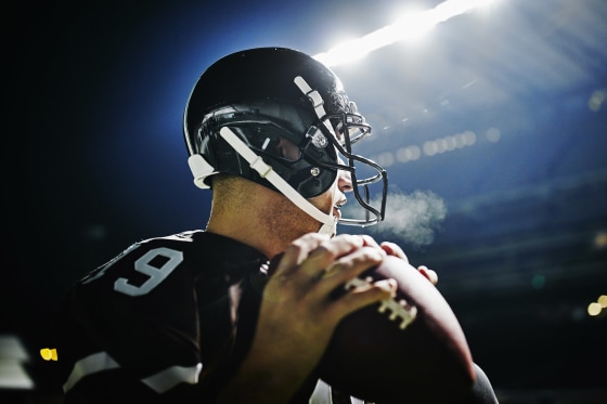 Image: Quarterback preparing to throw pass at night