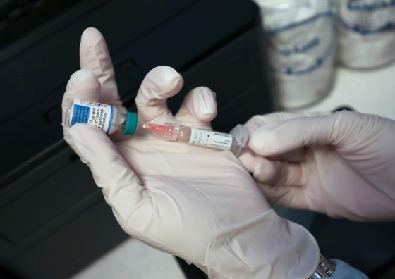 A Medical Assistant draws a measles, mumps and rubella, vaccination.