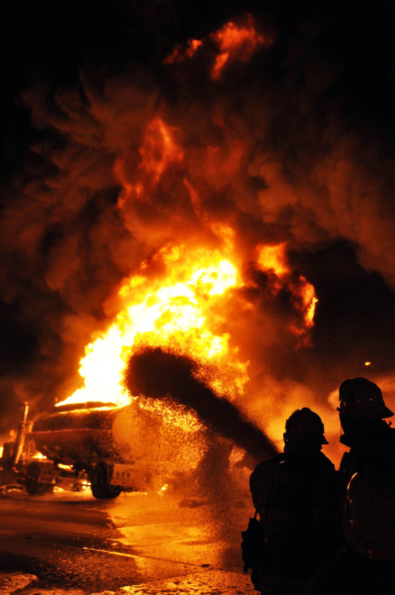 Firefighters use foam to extinguish a gasoline tanker fire in Glendale, Calif., Saturday, April 7.