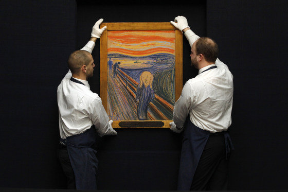 Sotheby's employees pose with Edvard Munch's painting "The scream" at Sotheby's auction in London on April 12.