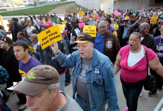Hundreds of protesters chant 'Pay your fair share