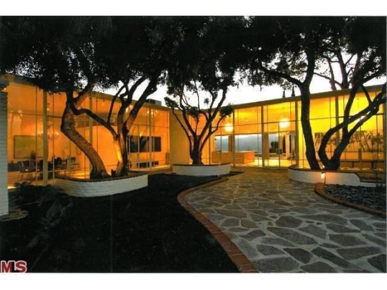 The glass-walled home cost a fortune to build in the 1950s.