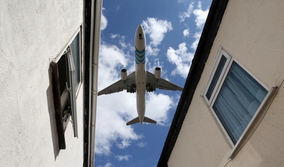 A passenger jet comes into land over houses next to Heathrow airport on August 28, in London, England. Transport Secretary Justine Greening has stated that the Government remains opposed to the building of a third runway at London's Heathrow airport despite calls from some Conservative Members of Parliament for the coalition to reconsider.