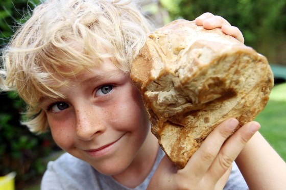Eight-year-old Charlie Naysmith shows off the piece of ambergris he found on the beach at Hengistbury Head on the coast of southern England.