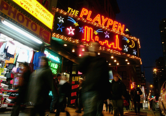 Pedestrians pass an adult store in Times Square in New York City. The state's supreme court on Thursday deemed that a set of amendments in 2001 meant to tighten the city's regulation of strip clubs, topless bars and adult video and book stores violated the constitutional protections of free speech and were unnecessary.