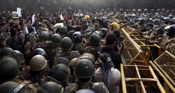 Indian security forces face students and activists shouting slogans, during a protest against the recent brutal gang-rape in New Delhi on Dec. 27.