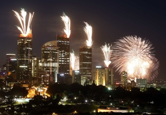 Fireworks explode on the rooftops of buildings during a 9 p.m. show prior to the new year celebrations in Sydney on Dec. 31, 2012.