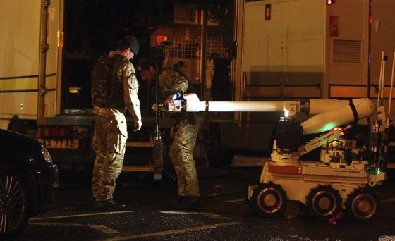 Army bomb disposal officers prepare to carry out a controlled explosion on a bomb discovered under a police officer's car in Belfast on Dec. 30.