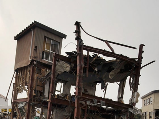 In this combo of two photos, a damaged house stands in a flooded residential area March 20, 2011, left, and the sun shines over the same area June 3, 2011 in Kesennuma, Miyagi Prefecture, northeastern Japan. Japan marks three month since the March 11 earthquake and tsunami Saturday, June 11, 2011. (AP Photo/Kyodo News) JAPAN OUT, MANDATORY CREDIT, NO LICENSING IN CHINA, HONG KONG, JAPAN, SOUTH KOREA AND FRANCE