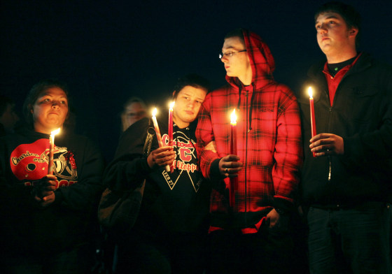 People gather outside St. Mary's of Chardon for a candlelight vigil remembering the victims of a school shooting in Chardon, Ohio February 28, 2012. Three students were killed and two others wounded by suspect TJ Lane in Monday's shooting rampage at the Ohio high school. REUTERS/Shannon Stapleton (UNITED STATES - Tags: CIVIL UNREST CRIME LAW EDUCATION)