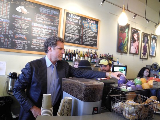 Will Ferrell randomly rearranges coffee cups as Zach Galifianakis talks to a barista at the Local Color coffeehouse in Seattle.