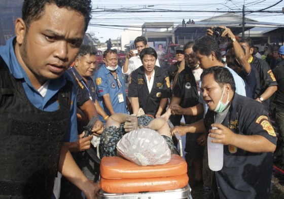 Rescue workers rush an injured woman to hospital following a car bomb attack at a business area in the Thai-Malaysian border district of Sungai Kolok, Narathiwat province, southern Thailand, on July 20, 2012.