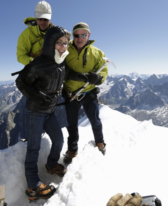 Former U.S. Congresswoman Gabrielle Giffords, center, stands with her husband Mark Kelly, right, NASA astronaut and commander of mission STS-134, and mountain guide Vincent Lameyre before Kelly and two other astronauts walked from L'Aiguille du Midi to the Refuge des Cosmiques near Mont-Blanc in Chamonix July 23.