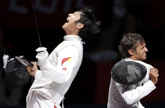 China's Lei Sheng, left, reacts during his men's individual foil semifinal fencing match against Italy's Andrea Baldini on July 31.