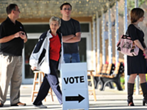 People wait before Republican presidential hopeful Newt Gingrich visits a voting precinct at the First Baptist Church of Windermere January 31, 2012 in Orlando, Florida.