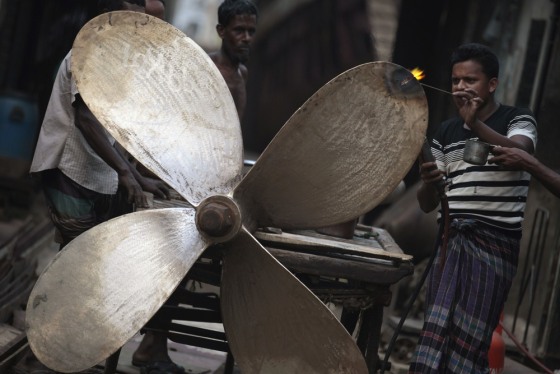 Workers make ship propellers at a metal workshop in a shipyard by the river Buriganga, on the outskirt of Dhaka on Thursday. Bangladesh will increase spending by nearly 19 percent in its budget for the coming year, Finance Minister Abul Maal Abdul Muhith said on Thursday, as it aims to ramp up economic growth to 7.2 percent.