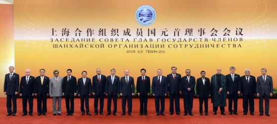 Shanghai Cooperation Organization (SCO) summit leaders and observers gather for a family photo, (from left to right)India's External Affairs Minister SM Krishna, President of Turkmenistan Gurbanguly Berdymukhamedov, Mongolia President Tsakhiagiin Elbegdorj, Uzbekistan's President Islam Karimov, Kyrgyzstan President Almazbek Sharshenovich Atambayev, Russian President Vladimir Putin, Chinese President Hu Jintao, Kazakhstan's President Nursultan Nazarbayev, Tajikistan's President Emomali Rakhmon, Pakistan President Asif Ali Zardari, Iranian President Mahmoud Ahmadinejad, Afghanistan President Hamid Karzai at the Great Hall of the People in Beijing June 7, 2012.