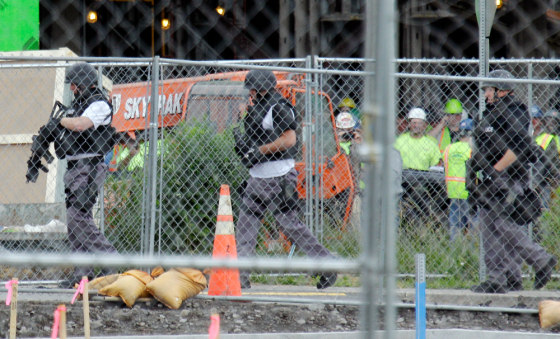 Police search the scene of a shooting at Erie Count Medical Center in Buffalo, N.Y., Wednesday, June 13, 2012. A police official confirmed Wednesday that a woman was killed on the grounds of the Erie County Medical Center. (AP Photo/David Duprey)