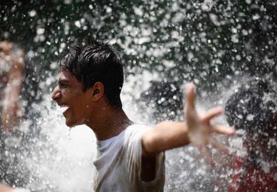 A boy enjoys the waterfall as he cleans himself after celebrating Asar Pandhra festival in Pokhara valley, west of Nepal's capital Kathmandu on June 29. Farmers in Nepal celebrate the festival to mark the commencement of rice crop planting in paddy fields.