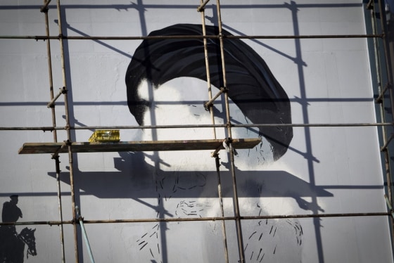 Scaffolding covers an unfinished mural of the late founder of the Islamic Republic of Iran, Ayatollah Ruhollah Khomeini, on a building at Enghelab (Revolution) square in Tehran on February 26, 2012. Iran's 48 million voters are being called on March 2 to decide their next parliament in elections whose turnout will be weighed to give an idea of support for the Islamic republic's regime. AFP PHOTO/BEHROUZ MEHRI (Photo credit should read BEHROUZ MEHRI/AFP/Getty Images)