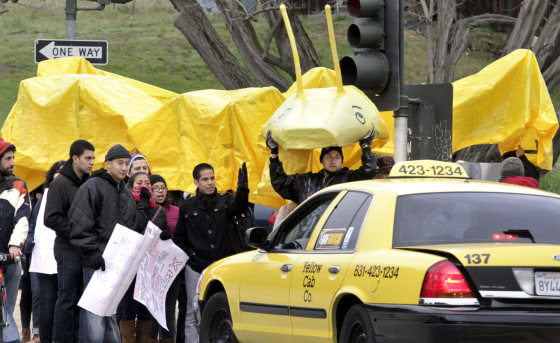 Shmuel Thaler/Sentinel Students holding a large banana slug block the main entrance to UC Santa Cruz on Thursday morning.