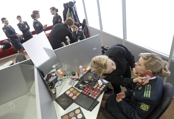 Ukrainian border guards take part in a master class in the Borispol airport near Kiev on Friday. Hairdressers and make-up artists conducted master classes for Ukrainian border guards who will meet tourists at Ukraine's main air hub during the Euro 2012 football championship. 