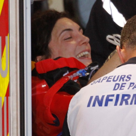 French journalist Edith Bouvier (L) is loaded onto an ambulance on a stretcher after her arrival on a government plane at Villacoublay military airport near Paris March 2, 2012. Freelance reporter Edith Bouvier, whose femur was shattered during heavy shelling of Homs's Baba Amro district, and photographer William Daniels were brought across the border into Lebanon by Syrian rebels on Thursday, ending several days of uncertainty over their fate. REUTERS/Charles Platiau (FRANCE - Tags: POLITICS MILITARY MEDIA)