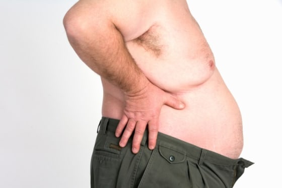Bare chested man holding hands on hips, mid section, obese, obesity, fat, overweight, pants, stock photography