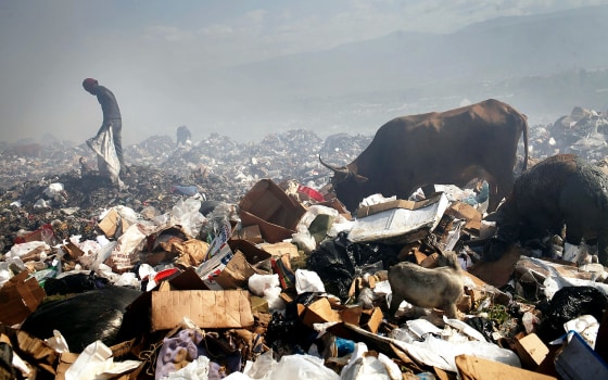 PORT-AU-PRINCE, HAITI - MARCH 07: Children and adults scavenge for recyclables and other usable items at the Trutier dump on the outskirts of Port-au-Prince, on March 7, 2012 in Port-au-Prince, Haiti. Following the devastating earthquake two years ago that killed and estimated 316,000 people, the number of scavengers at the landfill has grown from about 200 to an estimated 2,000. Much of Haiti is still in a crisis situation with tens of thousands living in tent camps in and around Port-au-Prince. A growing concern to international donors is a flare-up between ex-members of Haiti's armed forces and the current Haitian President Michel Martelly. (Photo by Spencer Platt/Getty Images)