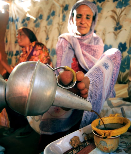 Hokom Al, a disabled woman, uses her foot to pour coffee which she prepared for neighbours at her home in a rural area in Khartoum March 7, 2012. Hokom Al, 45 years old, was born without hands. International Women's Day takes place on March 8. REUTERS/Mohamed Nureldin Abdallah (SUDAN - Tags: HEALTH SOCIETY)