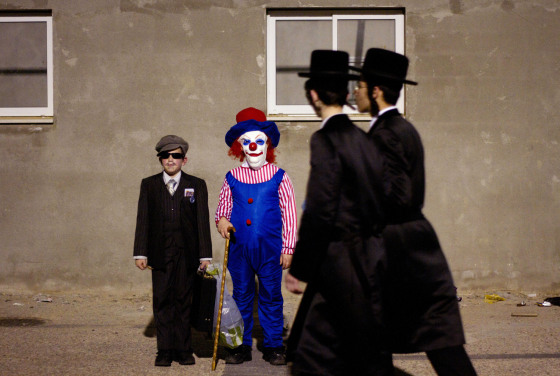 Ultra-Orthodox Jewish boys dressed for Purim pose for a photograph during celebration of Purim festival in Bnei Brak, near Tel Aviv, Israel, Wednesday, March 7, 2012. The Jewish holiday of Purim celebrates the Jews' salvation from genocide in ancient Persia, as recounted in the Scroll of Esther. (AP Photo/Ariel Schalit)