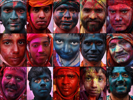 Men and boys are daubed in colored powder at a temple during